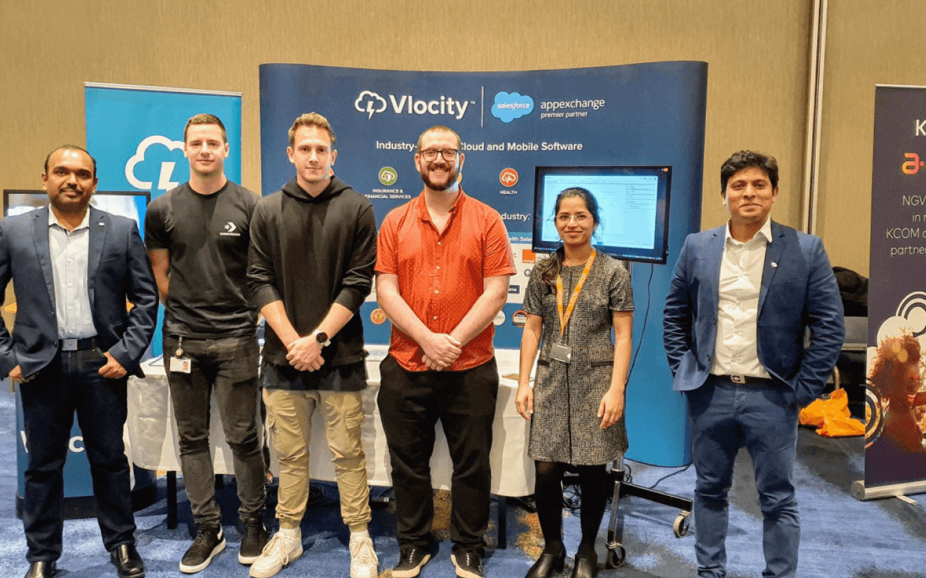 The image shows the UX team with Vlocity colleagues at the KCOM Tech Expo.